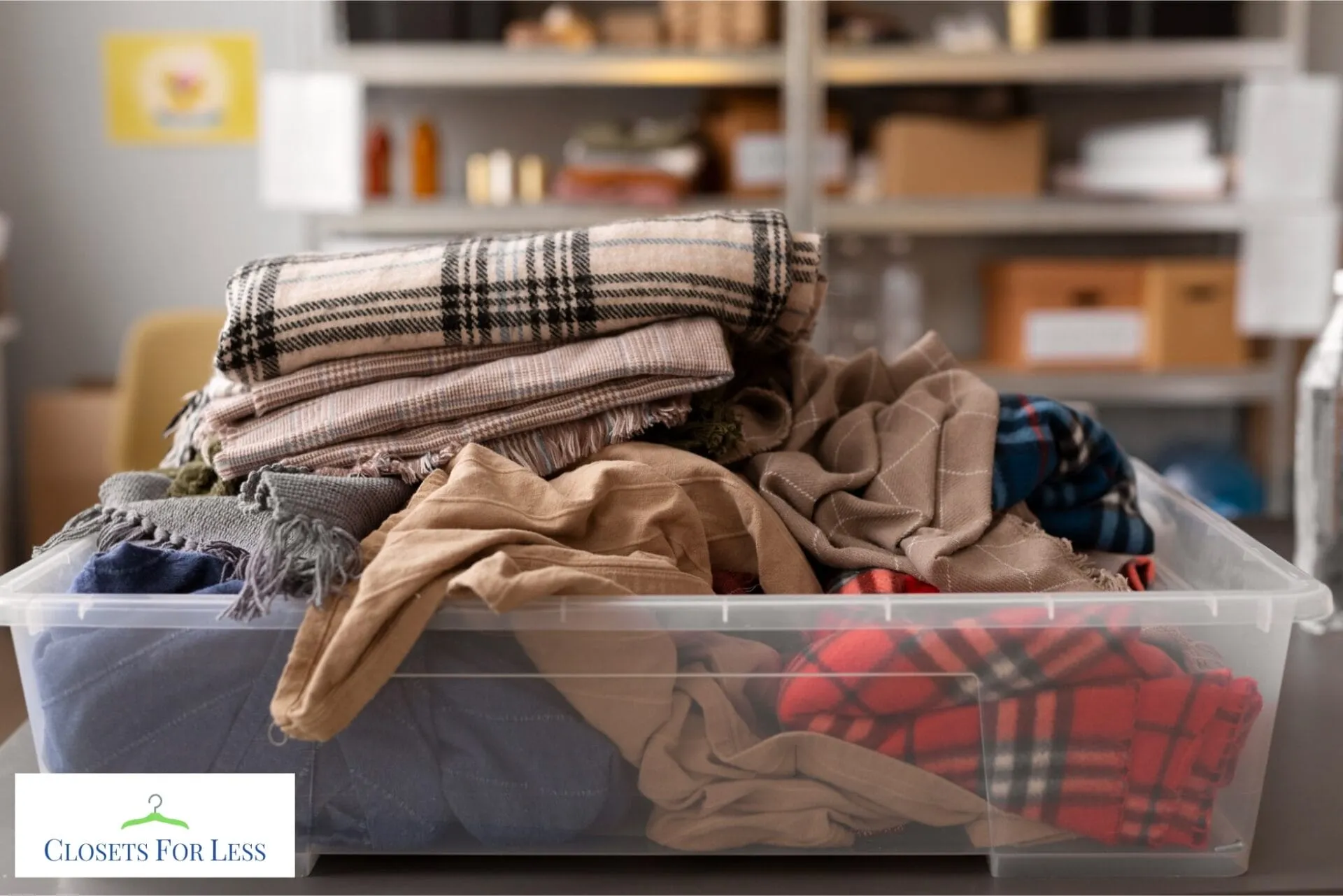 Clear plastic storage bin overflowing with folded blankets and clothing, showing cluttered closet storage before organization.