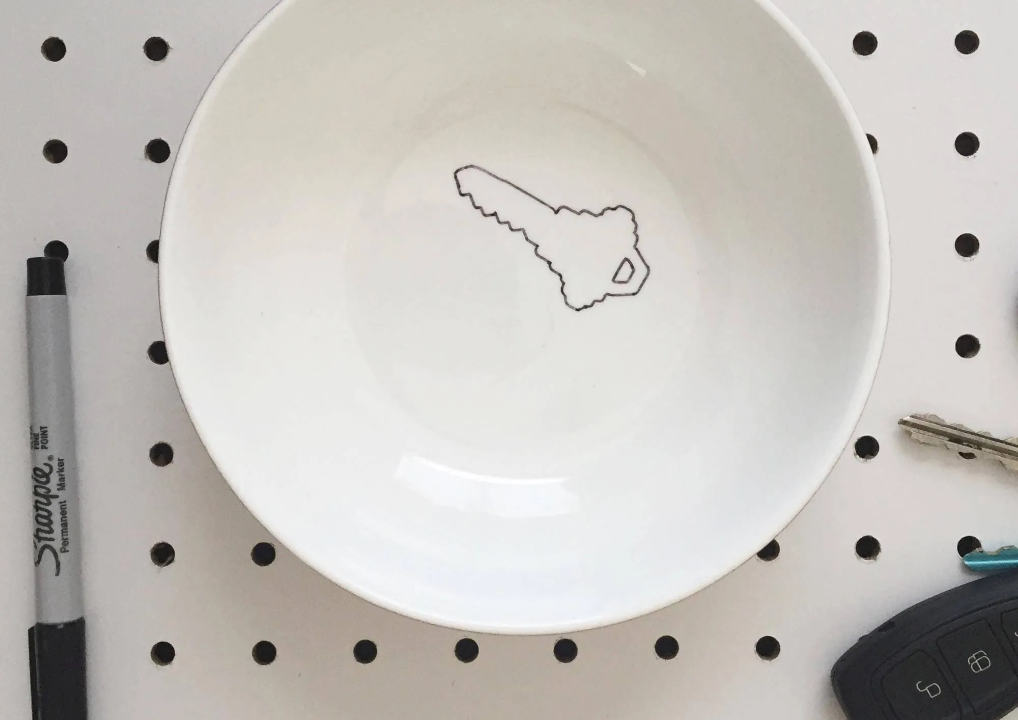white bowl with outline of key