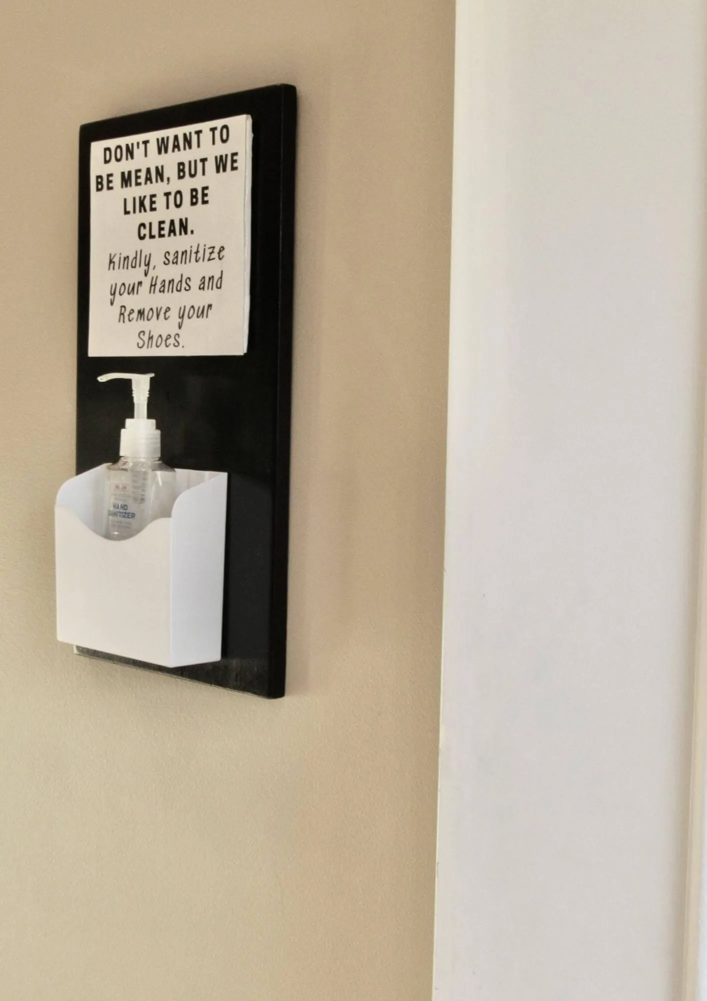hanging hand sanitizer station with pump and sign