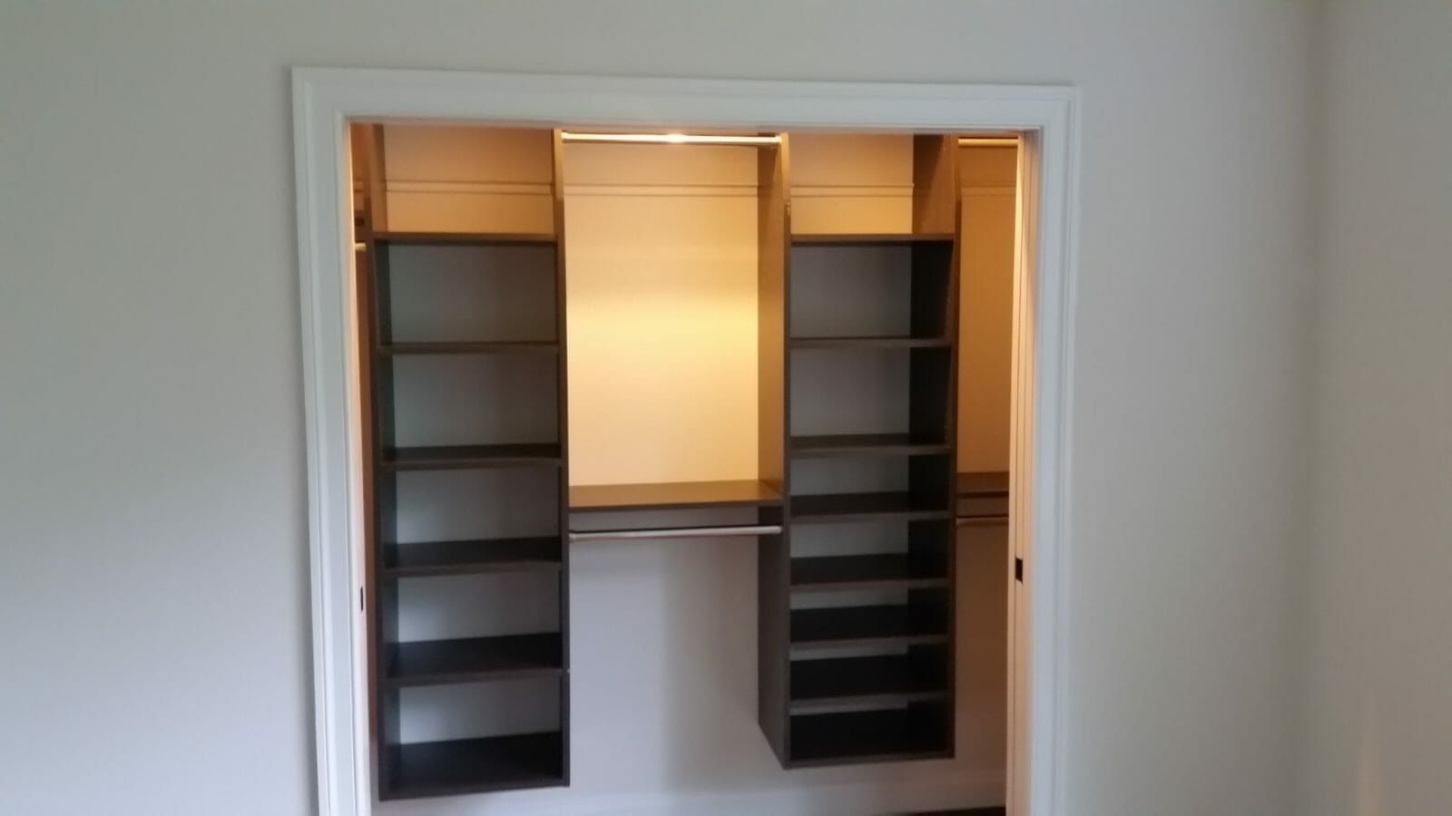 Reach-in closet espresso shelving, installed by Closets For Less