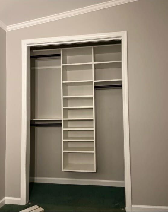 Gray reach-in closet with a narrow shoe tower