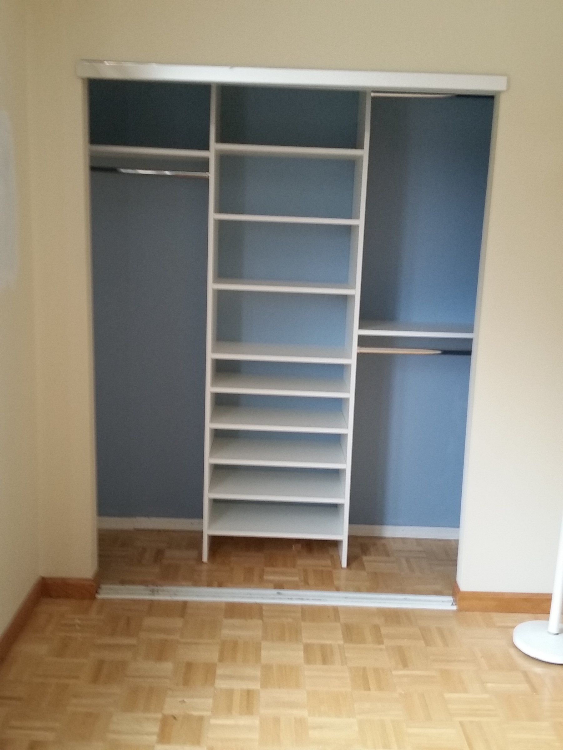 Reach-in closet with a white shoe tower