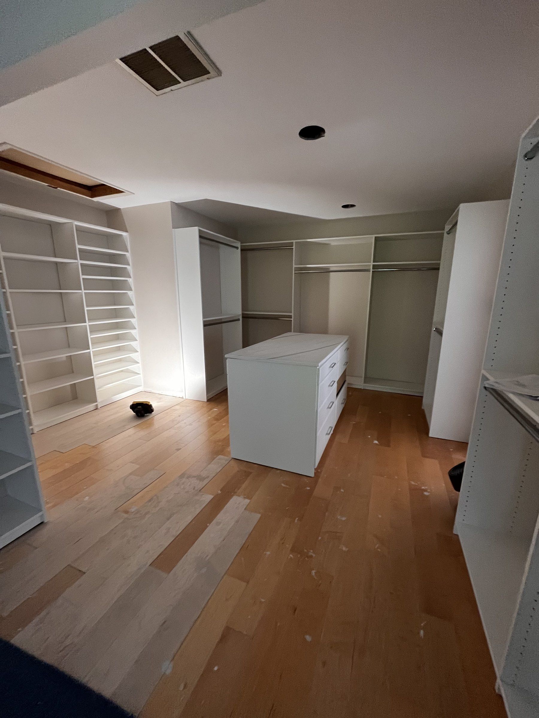 Walk-in closet island wood floor, installed by Closets For Less