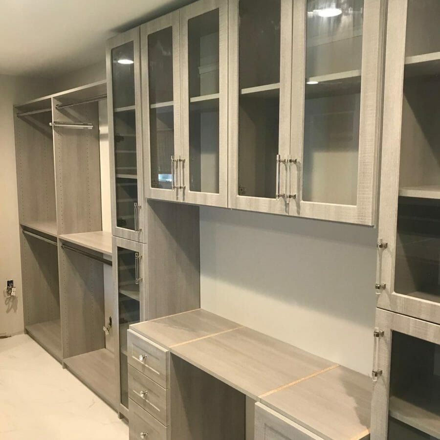 Walk-in closet vanity glass uppers, installed by Closets For Less