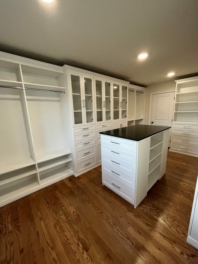 White walk-in closet black island top, installed by Closets For Less
